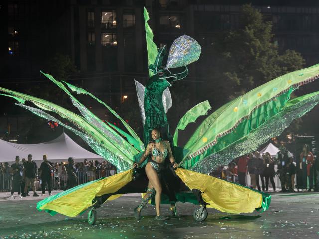 (260731) -- TORONTO, July 31, 2026 (Xinhua) -- A dressed-up competitor performs during the King and Queen Showcase of the 2026 Toronto Caribbean Carnival in Toronto, Canada, on July 30, 2026. Over 30 masqueraders in elaborate costumes participated in this annual event here on Thursday to compete for the titles of King and Queen of the Carnival. (Photo by Zou Zheng/Xinhua)