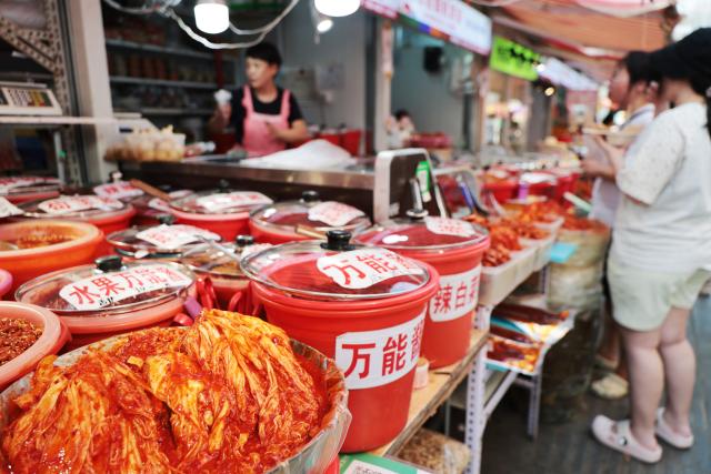 (260731) -- SHENYANG, July 31, 2026 (Xinhua) -- This photo taken on July 23, 2026 shows kimchi cabbage and specialty sauces at the Xita neighborhood in Shenyang, northeast China's Liaoning Province. Xita is a distinctive neighborhood in Shenyang which is known for its wide variety of local specialties and attracts visitors from across the country. (Xinhua/Li Gang)