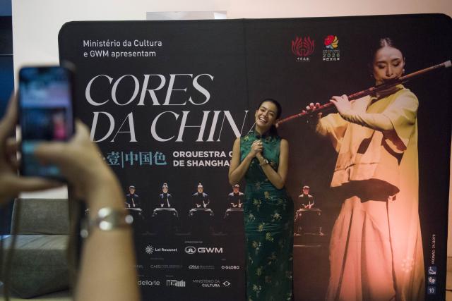 (260731) -- RIO DE JANEIRO, July 31, 2026 (Xinhua) -- An audience poses for photos in front of the exhibition board after the "Colors of China" concert in Rio de Janeiro, Brazil, July 30, 2026. The concert was staged here on Thursday, marking the start of its tour performance at six cities in Brazil. (Photo by Daniel Ramalho/Xinhua)