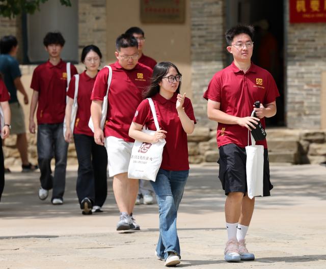 (260731) -- YAN'AN, July 31, 2026 (Xinhua) -- University students take part in a study tour at the Zaoyuan, or Jujube Orchard literally, in Yan'an, northwest China's Shaanxi Province, on July 30, 2026. During the summer vacation, Yan'an, an old revolutionary base, has seen a surge in tourists, with its revolutionary sites and performances continuing to attract visitors. (Xinhua/Li Yibo)