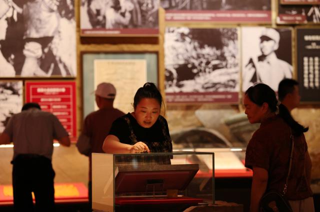 (260731) -- YAN'AN, July 31, 2026 (Xinhua) -- Tourists visit the Yan'an Revolutionary Memorial Hall in Yan'an, northwest China's Shaanxi Province, on July 30, 2026. During the summer vacation, Yan'an, an old revolutionary base, has seen a surge in tourists, with its revolutionary sites and performances continuing to attract visitors. (Xinhua/Li Yibo)