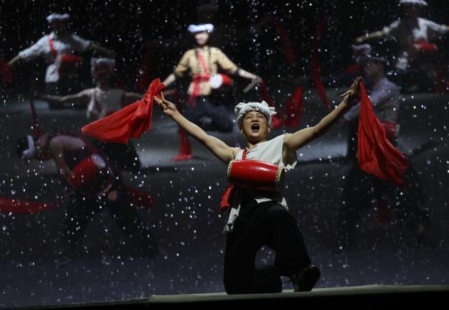 (260731) -- YAN'AN, July 31, 2026 (Xinhua) -- Actors perform a revolutionary-themed immersive drama in Yan'an, northwest China's Shaanxi Province, on July 29, 2026. During the summer vacation, Yan'an, an old revolutionary base, has seen a surge in tourists, with its revolutionary sites and performances continuing to attract visitors. (Xinhua/Li Yibo)