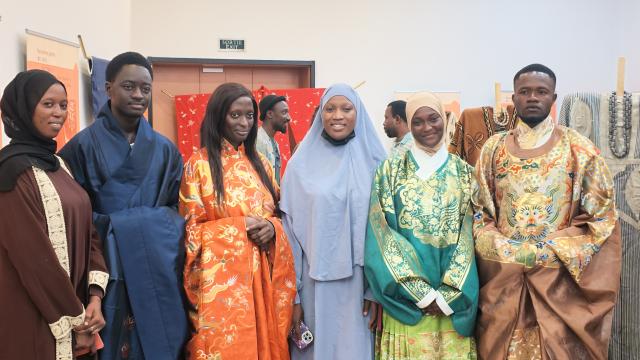(260731) -- DAKAR, July 31, 2026 (Xinhua) -- Students from the Confucius Institute at Cheikh Anta Diop University try traditional Chinese costumes during an exhibition on ancient Chinese clothing culture at the Museum of Black Civilizations in Dakar, Senegal, July 29, 2026. TO GO WITH "Exhibition on ancient Chinese clothing culture opens in Senegal" (Xinhua/Qi Qi)