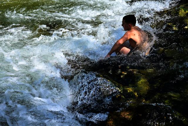 (260731) -- SKOPJE, July 31, 2026 (Xinhua) -- A man cools off in the Treska River to escape the summer heat near Skopje, North Macedonia, July 31, 2026. (Photo by Tomislav Georgiev/Xinhua)