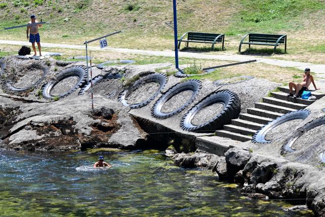 (260731) -- SKOPJE, July 31, 2026 (Xinhua) -- A man cools off in the Treska River to escape the summer heat near Skopje, North Macedonia, July 31, 2026. (Photo by Tomislav Georgiev/Xinhua)