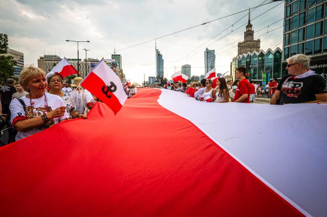 (260802) -- WARSAW, Aug. 2, 2026 (Xinhua) -- People take part in a march commemorating the 82nd anniversary of the Warsaw Uprising in Warsaw, Poland, Aug. 1, 2026. The Warsaw Uprising, which broke out on Aug. 1, 1944, was the largest underground military operation in German-occupied Europe. Around 40,000-50,000 Polish insurgents took part in the two-month struggle, which resulted in the deaths of approximately 18,000 fighters and up to 180,000 civilians. (Photo by Jaap Arriens/Xinhua)