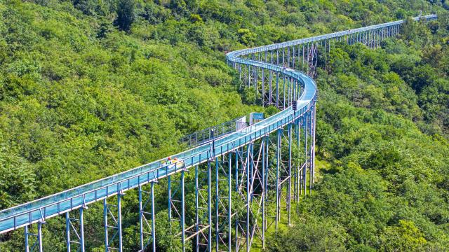(260802) -- CHUZHOU, Aug. 2, 2026 (Xinhua) -- A drone photo taken on Aug. 2, 2026 shows tourists trying drifting at the Langya Mountain scenic area in Chuzhou, east China's Anhui Province. Located in the southwest of Chuzhou, the Langya Mountain scenic area is home to the renowned Zuiweng Pavilion, which was featured in a celebrated essay by Northern Song Dynasty literary figure Ouyang Xiu. In summer, the scenic area attracts visitors with daytime sightseeing and nighttime markets. (Photo by Ji Chengjun/Xinhua)