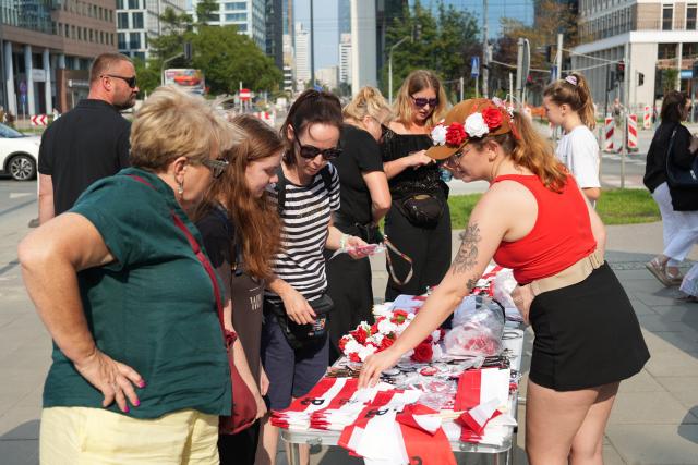 (260802) -- WARSAW, Aug. 2, 2026 (Xinhua) -- People select flags and commemorative items ahead of events marking the 82nd anniversary of the Warsaw Uprising in Warsaw, Poland, Aug. 1, 2026. The Warsaw Uprising, which broke out on Aug. 1, 1944, was the largest underground military operation in German-occupied Europe. Around 40,000-50,000 Polish insurgents took part in the two-month struggle, which resulted in the deaths of approximately 18,000 fighters and up to 180,000 civilians. (Xinhua/Yue Yuanyuan)