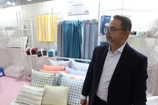 (260802) -- NEW YORK, Aug. 2, 2026 (Xinhua) -- Khurram Shafique, director of sales with U.S.-based home textile brand Utopia Brands, is seen at Texworld NYC, a textile sourcing trade show, in New York City, the United States, July 30, 2026. TO GO WITH "Economic Watch: Exhibitors at U.S. textile trade show grapple with unprecedented headwinds" (Photo by Li Xirui/Xinhua)