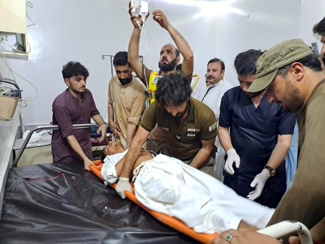 (260802) -- ISLAMABAD, Aug. 2, 2026 (Xinhua) -- Rescuers transfer an injured man in Khyber Pakhtunkhwa province, Pakistan, Aug. 2, 2026. The death toll from a suicide blast near a peace rally in Pakistan's northwestern Khyber Pakhtunkhwa province has risen to 14, while 26 others were injured, police sources told Xinhua on Sunday. (Str/Xinhua)