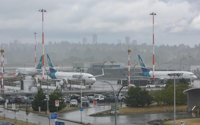 (260802) -- VANCOUVER, Aug. 2, 2026 (Xinhua) -- Grounded WestJet aircraft are seen at Vancouver International Airport in Richmond, British Columbia, Canada, on Aug. 2, 2026. Canada's second-largest airline, WestJet, was hit by a flight attendants' strike on Sunday, triggering hundreds of flight cancellations during one of the busiest travel weekends of the summer. (Photo by Liang Sen/Xinhua)