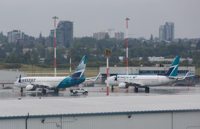 (260802) -- VANCOUVER, Aug. 2, 2026 (Xinhua) -- Grounded WestJet aircraft are seen at Vancouver International Airport in Richmond, British Columbia, Canada, on Aug. 2, 2026. Canada's second-largest airline, WestJet, was hit by a flight attendants' strike on Sunday, triggering hundreds of flight cancellations during one of the busiest travel weekends of the summer. (Photo by Liang Sen/Xinhua)