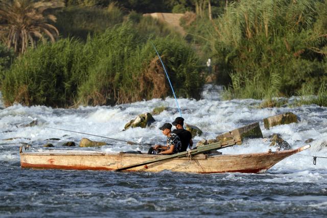 (260802) -- CAIRO, Aug. 2, 2026 (Xinhua) -- People fish at a riffle on the Nile River to escape the heat of summer in Qalyubia Governorate, Egypt, on August 2, 2026. (Photo by Ahmed Gomaa/Xinhua)