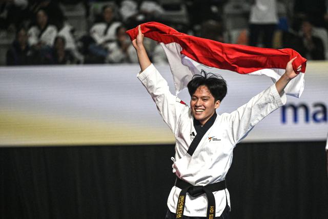 (260803) -- JAKARTA, Aug. 3, 2026 (Xinhua) -- Andi Sultan of Indonesia celebrates after winning the Men Over 17 Poomsae Freestyle Individual of Taekwondo on the 8th Asian Taekwondo Indonesia Open Championships 2026 in Jakarta, Indonesia, Aug. 2, 2026. (Xinhua/Agung Kuncahya B.)