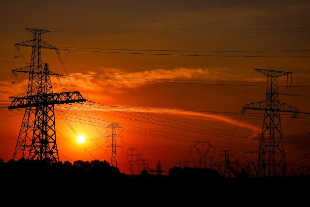 (260803) -- BUDAPEST, Aug. 3, 2026 (Xinhua) -- Power transmission facilities are seen from the banks of the Danube River near Dunaszentbenedek, Hungary, Aug. 2, 2026. Hungary is entering its "most critical 5 days" as dropping water levels on the Danube River threaten the complete shutdown of the Paks nuclear power plant amid an extreme heatwave, Hungary's Prime Minister Peter Magyar said on Sunday, warning that the plant could be shut down for more than a month. (Photo by David Balogh/Xinhua)