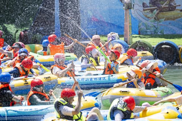 (260803) -- BEIJING, Aug. 3, 2026 (Xinhua) -- Tourists enjoy drifting at the Langya Mountain scenic area in Chuzhou, east China's Anhui Province, Aug. 2, 2026. Located in the southwest of Chuzhou, the Langya Mountain scenic area is home to the renowned Zuiweng Pavilion, which was featured in a celebrated essay by Northern Song Dynasty literary figure Ouyang Xiu. In summer, the scenic area attracts visitors with daytime sightseeing and nighttime markets. (Photo by Ji Chengjun/Xinhua)