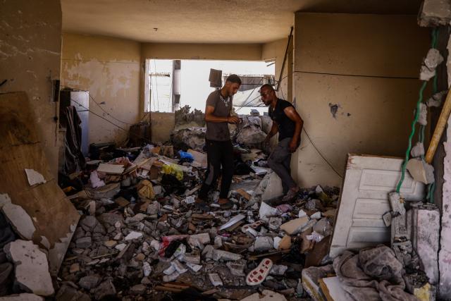 (260803) -- GAZA, Aug. 3, 2026 (Xinhua) -- Palestinians check the ruins after an Israeli airstrike hit an apartment in Gaza City, on Aug. 2, 2026. At least 18 Palestinians were killed in Israeli airstrikes on the Gaza Strip since dawn on Sunday, despite announcements of progress in efforts to implement a ceasefire agreement.
  The strikes targeted residential apartments, tents sheltering displaced people, civilian vehicles, and Palestinian gatherings from the north to the south of the Gaza Strip, resulting in the deaths of at least 18 people, including four children and two women, said Mahmoud Basal, spokesperson for the Civil Defense in Gaza. (Photo by Rizek Abdeljawad/Xinhua)