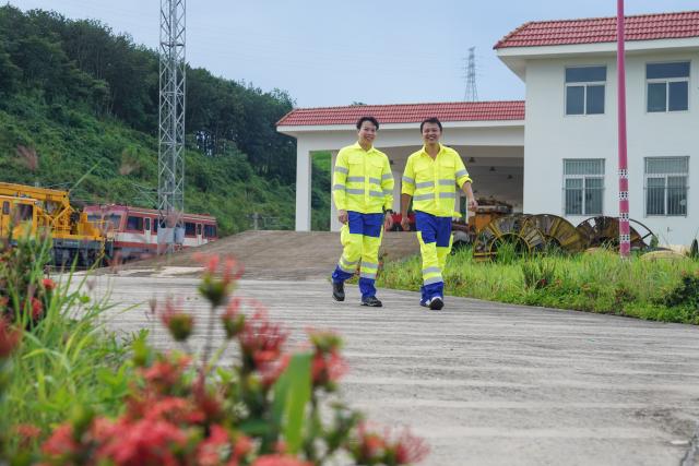 (260803) -- VIENTIANE, Aug. 3, 2026 (Xinhua) -- Chinese mentor Li Li (R) and his Lao apprentice Bounyadeth Thepvongsa are pictured at the Meuangxay Comprehensive Maintenance Workshop of the China-Laos Railway in Meuangxay, Laos, July 30, 2026. TO GO WITH "Feature: From protecting homelands to safeguarding railway -- Retired veterans, apprentices on China-Laos Railway" (Photo by Pu Hongsi/Xinhua)