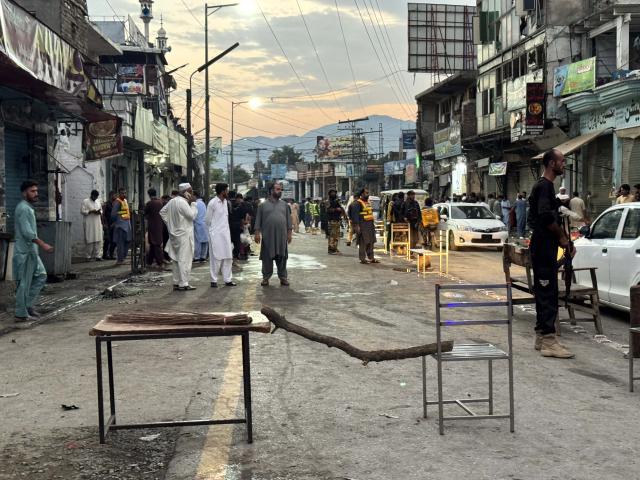 (260803) -- SWAT, Aug. 3, 2026 (Xinhua) -- This photo taken with a mobile phone on Aug. 2, 2026 shows people gathering at a suicide blast site in Swat district, Khyber Pakhtunkhwa province, Pakistan. The death toll from a suicide blast near a peace rally in Pakistan's northwestern Khyber Pakhtunkhwa province has risen to 14, while 26 others were injured, police sources told Xinhua on Sunday. (Str/Xinhua)