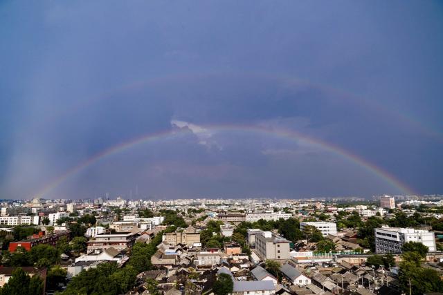 (260803) -- BEIJING, Aug. 3, 2026 (Xinhua) -- Rainbows appear in the sky after rain in Beijing, capital of China, Aug. 3, 2026. (Xinhua/Du Juanjuan)
