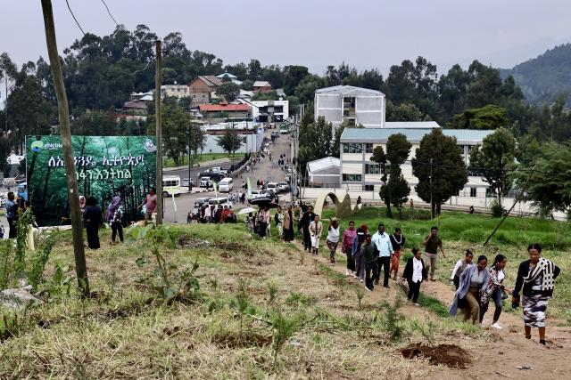 (260803) -- ADDIS ABABA, Aug. 3, 2026 (Xinhua) -- People take part in a nationwide tree-planting campaign as part of the country's flagship Green Legacy Initiative in Addis Ababa, the capital of Ethiopia, Aug. 3, 2026. Millions of Ethiopians and foreign nationals in the country took part in a nationwide tree-planting campaign on Monday, aiming to plant a record-breaking 800 million tree seedlings in a single day as part of the national reforestation drive. The nationwide event is part of the country's flagship Green Legacy Initiative, launched by Prime Minister Abiy Ahmed in 2019. As part of this year's edition of the initiative, the East African country aims to plant a total of more than 8 billion seedlings in the rainy season. (Xinhua/Geng Xinning)