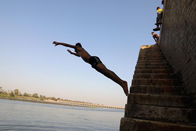 (260803) -- CAIRO, Aug. 3, 2026 (Xinhua) -- A man jumps into the Nile River to escape the heat in Cairo, Egypt, Aug. 3, 2026. (Xinhua/Ahmed Gomaa)