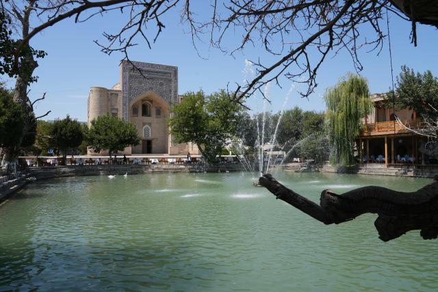 (260803) -- BUKHARA, Aug. 3, 2026 (Xinhua) -- A fountain sprays water at the Lyabi-Khauz pool in the historic city of Bukhara, Uzbekistan, Aug. 3, 2026. The historic city of Bukhara in southwestern Uzbekistan is currently gripping with severe heat, with daytime highs consecutively exceeding 35 degrees Celsius. (Photo by Zafar Khalilov/Xinhua)