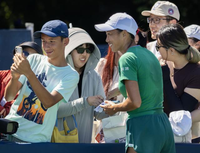 (260804) -- TORONTO, Aug. 4, 2026 (Xinhua) -- A fan takes a selfie with Zhang Shuai (front) of China after the first round of the women's singles match between Yulia Putintseva of Kazakhstan and Zhang Shuai of China at the 2026 National Bank Open tennis tournament in Toronto, Canada, on Aug. 3, 2026. (Photo by Zou Zheng/Xinhua)