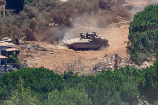 (260804) -- ZAWTAR AL-GHARBIYAH, Aug. 4, 2026 (Xinhua) -- This photo taken on Aug. 3, 2026 shows an Israeli military vehicle stationed in Zawtar al-Sharqiyah, southern Lebanon. The Lebanese army said on July 26 that continued Israeli attacks and violations of existing understandings are obstructing its deployment in southern Lebanon and delaying the return of residents to their border villages. (Photo by Ali Hashisho/Xinhua)