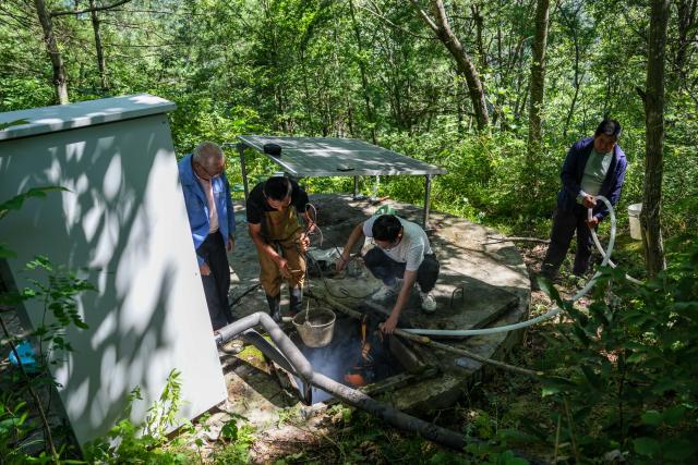 (260804) -- KANGXIAN, Aug. 4, 2026 (Xinhua) -- Locals attempt to restore a water tank at Zhangjiahe Village of Kangxian County in Longnan City, northwest China's Gansu Province, Aug. 4, 2026. Kangxian, which suffered from heavy rainfall recently, has initiated campaigns to clear up rivers and restore drinking water facilities in the county, striving to bring people's work and daily life back to normal. (Xinhua/Lang Bingbing)