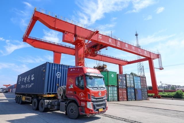 (260804) -- SHIJIAZHUANG, Aug. 4, 2026 (Xinhua) -- A cargo truck enters the Shijiazhuang international land port in north China's Hebei Province, Aug. 4, 2026. Shijiazhuang international land port in north China's Hebei Province handled a total of 814 China-Europe and China-Central Asia freight train trips in the first half of 2026, up 42.06 percent year on year. (Photo by Liang Zidong/Xinhua)
