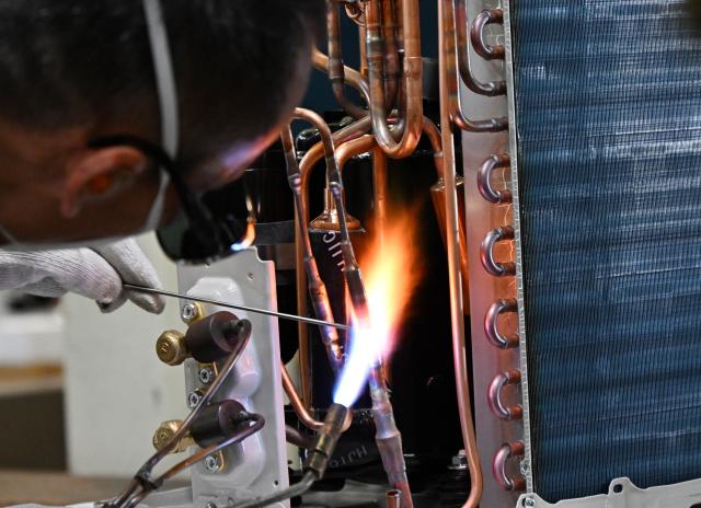 (260804) -- QINGDAO, Aug. 4, 2026 (Xinhua) -- A worker produces air conditioners for export to Europe at a Haier factory in Jiaozhou, east China's Shandong Province, Aug. 4, 2026. As unprecedented heatwaves scorch Europe this summer, demand for affordable and energy-efficient air conditioners is rising.
   As a globally renowned home appliance manufacturer, China's Haier has seen a surge in orders from Europe. The company has adjusted its production plans for the European market, stepping up the manufacturing of air conditioner orders to meet international market demand. (Xinhua/Li Ziheng)