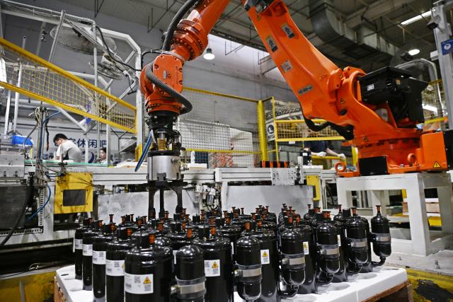 (260804) -- QINGDAO, Aug. 4, 2026 (Xinhua) -- A robotic arm produces air conditioners for export to Europe at a Haier factory in Jiaozhou, east China's Shandong Province, Aug. 4, 2026. As unprecedented heatwaves scorch Europe this summer, demand for affordable and energy-efficient air conditioners is rising.
   As a globally renowned home appliance manufacturer, China's Haier has seen a surge in orders from Europe. The company has adjusted its production plans for the European market, stepping up the manufacturing of air conditioner orders to meet international market demand. (Xinhua/Li Ziheng)