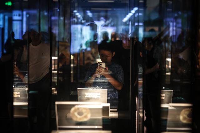 (260804) -- CHAOYANG, Aug. 4, 2026 (Xinhua) -- A boy visits the Niuheliang site museum at the Niuheliang national archaeological relic site park in Chaoyang City, northeast China's Liaoning Province, Aug. 4, 2026. The Niuheliang national archaeological relic site park was built on the Niuheliang site, a large-scale prehistoric ritual and burial complex featuring the temple of the goddess, altars and stone tombs. Dating back more than 5,000 years, the site unearthed stone tools, pottery and jade artifacts with dragon, phoenix and human motifs, reflecting the rituals and beliefs of the Hongshan culture. (Xinhua/Pan Yulong)