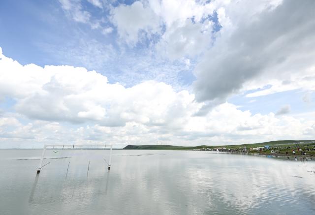 (260804) -- XILIN GOL, Aug. 4, 2026 (Xinhua) -- This photo taken on Aug. 4, 2026 shows a view of Baiyin Chagan Lake, or "Milky Lake," in Xilin Gol League, north China's Inner Mongolia Autonomous Region. The lake is dubbed "Milky Lake" as tiny mineral particles float in the water, turning it creamy-white like milk. (Xinhua/Lian Zhen)