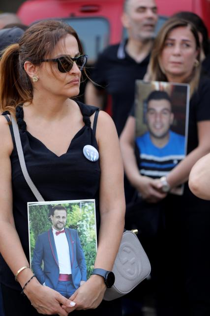 (260804) -- BEIRUT, Aug. 4, 2026 (Xinhua) -- People hold portraits of the victims in commemoration of the sixth anniversary of the 2020 Beirut port blasts in Beirut, Lebanon, Aug. 4, 2026. (Xinhua/Bilal Jawich)