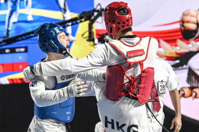 (260805) -- JAKARTA, Aug. 5, 2026 (Xinhua) -- Matthew Summerfield (L) of Australia competes with Wai Fung Lo of China's Hong Kong during the men's Kyorugi -68kg final match of Taekwondo at the 8th Asian Taekwondo Indonesia Open Championships 2026 in Jakarta, Indonesia, Aug. 4, 2026. (Xinhua/Agung Kuncahya B.)