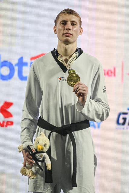 (260805) -- JAKARTA, Aug. 5, 2026 (Xinhua) -- Gold medalist Vladislav Budin of Russia poses at the awarding ceremony for the men's Kyorugi -87kg final match of Taekwondo at the 8th Asian Taekwondo Indonesia Open Championships 2026 in Jakarta, Indonesia, Aug. 4, 2026. (Xinhua/Agung Kuncahya B.)