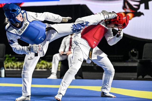 (260805) -- JAKARTA, Aug. 5, 2026 (Xinhua) -- Grabriella Blewitt (L) of Australia competes with Ingrid Poetri Iskandar of Singapore during the women's Kyorugi -62kg final match of Taekwondo at the 8th Asian Taekwondo Indonesia Open Championships 2026 in Jakarta, Indonesia, Aug. 4, 2026. (Xinhua/Agung Kuncahya B.)