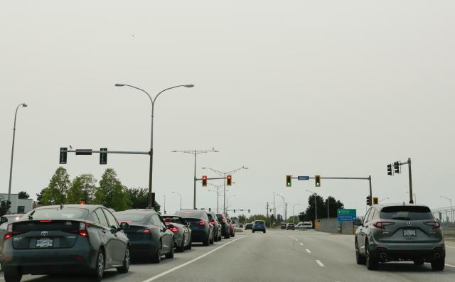 (260805) -- VANCOUVER, Aug. 5, 2026 (Xinhua) -- Vehicles run on a road under smoky sky in Vancouver, British Columbia, Canada, Aug. 4, 2026. Amid extreme heatwaves and record-breaking drought, wildfires have broken out in many parts of Canada, reducing air quality and visibility in the affected areas. (Photo by Liang Sen/Xinhua)