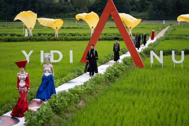 (260805) -- YUEXI, Aug. 5, 2026 (Xinhua) -- Models dressed in traditional ethnic costumes walk amid a rice field during a fashion show at Qietuo Village in Yuexi County of Liangshan Yi Autonomous Prefecture, southwest China's Sichuan Province, on Aug. 4, 2026. Sixty models from across the Liangshan Yi Autonomous Prefecture on Tuesday showcased traditional ethnic costumes and fashion creations here. (Xinhua/Jiang Hongjing)