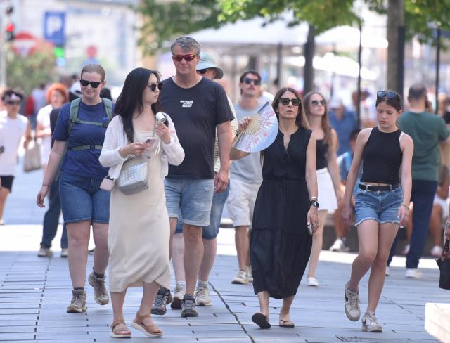 (260805) -- VIENNA, Aug. 5, 2026 (Xinhua) -- People are seen on a street in Vienna, Austria, Aug. 5, 2026. A 41 degrees Celcius temperature record was set in Austria on Tuesday, together with forest fires and low Danube water levels in the Alpine country. (Xinhua/He Canling)