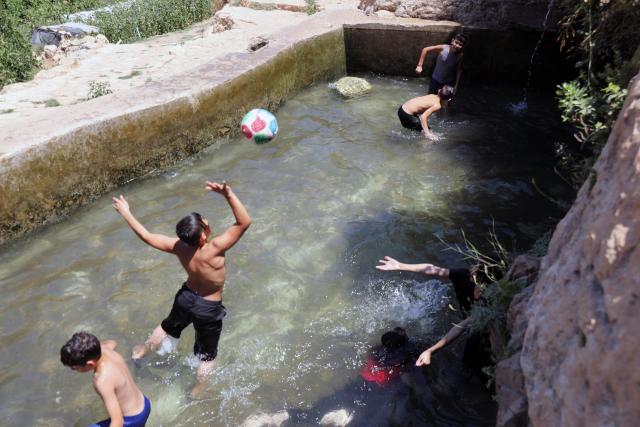 (260805) -- BETHLEHEM, Aug. 5, 2026 (Xinhua) -- Palestinian teenagers cool off at a pond during hot summer day in the village of Battir, west of the West Bank city of Bethlehem on Aug. 5, 2026. (Photo by Mamoun Wazwaz/Xinhua)