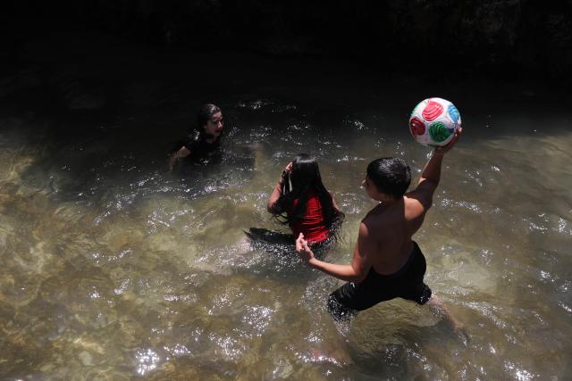 (260805) -- BETHLEHEM, Aug. 5, 2026 (Xinhua) -- Palestinian teenagers cool off at a pond during hot summer day in the village of Battir, west of the West Bank city of Bethlehem on Aug. 5, 2026. (Photo by Mamoun Wazwaz/Xinhua)