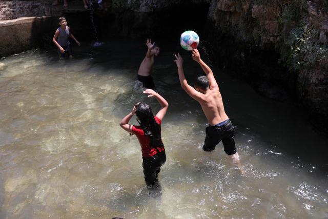 (260805) -- BETHLEHEM, Aug. 5, 2026 (Xinhua) -- Palestinian teenagers cool off at a pond during hot summer day in the village of Battir, west of the West Bank city of Bethlehem on Aug. 5, 2026. (Photo by Mamoun Wazwaz/Xinhua)