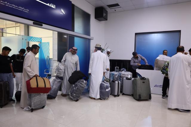 (260805) -- DEIR AL-ZOUR, Aug. 5, 2026 (Xinhua) -- Passengers collect their luggage after the first direct commercial flight from Kuwait landed at Deir al-Zour International Airport in Deir al-Zour province, eastern Syria, Aug. 5, 2026. The first direct commercial flight from Kuwait landed Wednesday at Deir al-Zour International Airport in eastern Syria, marking the return of international commercial air services to the airport after more than a decade. (Str/Xinhua)