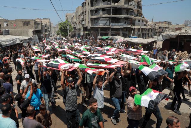 (260806) -- BEIJING, Aug. 6, 2026 (Xinhua) -- Palestinians attend the mass funeral of 112 victims in Gaza City on Aug. 4, 2026.
  The funeral came after the remains of the victims were recently recovered from beneath the rubble of houses destroyed in an Israeli airstrike in November 2023. (Photo by Rizek Abdeljawad/Xinhua)