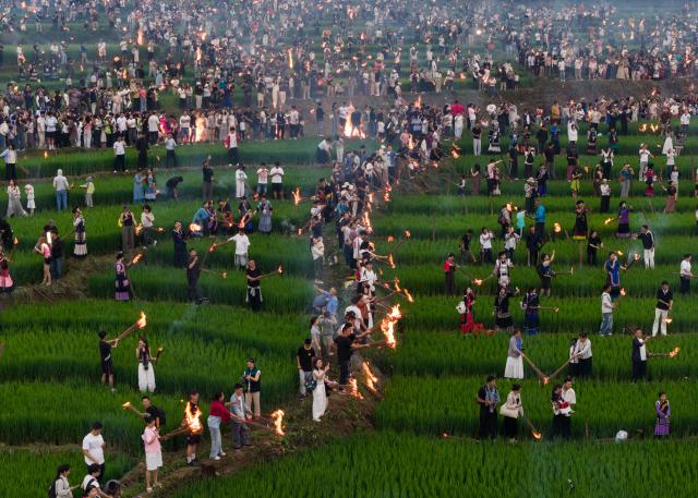 (260806) -- BEIJING, Aug. 6, 2026 (Xinhua) -- An aerial drone photo taken on Aug. 4, 2026 shows people of the Yi ethnic group celebrating the torch festival with visitors at a terraced field in Yangpo Village, Yuexi County of southwest China's Sichuan Province. From Aug. 2 to 4, a torch festival tourism season was held in Yuexi County of southwest China's Sichuan. The event featured torch carnival nights, folk cultural competitions, dancing and singing contests. 
  The torch festival is a traditional celebration of the Yi ethnic group, usually held around the 24th day of the sixth month on the Chinese lunar calendar each year. (Xinhua/Jiang Hongjing)