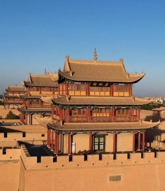 (260806) -- JIAYUGUAN, Aug. 6, 2026 (Xinhua) -- A drone photo taken on Aug. 5, 2026 shows a view of the Jiayu Pass at sunset in the city of Jiayuguan, northwest China's Gansu Province. The Jiayu Pass is the starting point of a section of the Great Wall constructed during the Ming Dynasty (1368-1644). The pass also served as a vital passage on the ancient Silk Road. (Xinhua/Chen Bin)