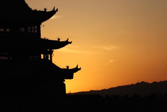 (260806) -- JIAYUGUAN, Aug. 6, 2026 (Xinhua) -- This photo taken on Aug. 5, 2026 shows a view of the Jiayu Pass at sunset in the city of Jiayuguan, northwest China's Gansu Province. The Jiayu Pass is the starting point of a section of the Great Wall constructed during the Ming Dynasty (1368-1644). The pass also served as a vital passage on the ancient Silk Road. (Xinhua/Chen Bin)